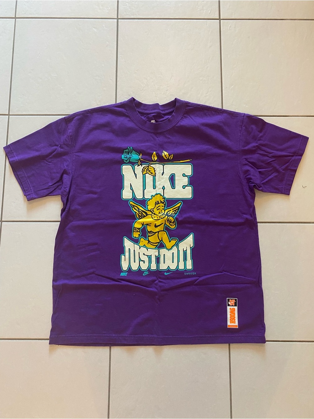 Nike Purple Graphic Tee with Yellow Cherub and Teal Accents